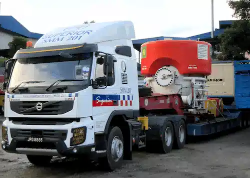 Low loader trailer transporting heavy cargo on a highway in Malaysia