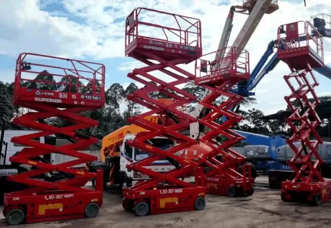 Multiple scissor lifts for rental parked at the Superior Heavy Equipment yard